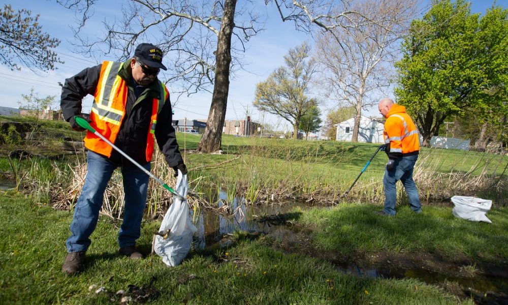 Volunteers with Bring Back the Boulevard pick up trash, debris in